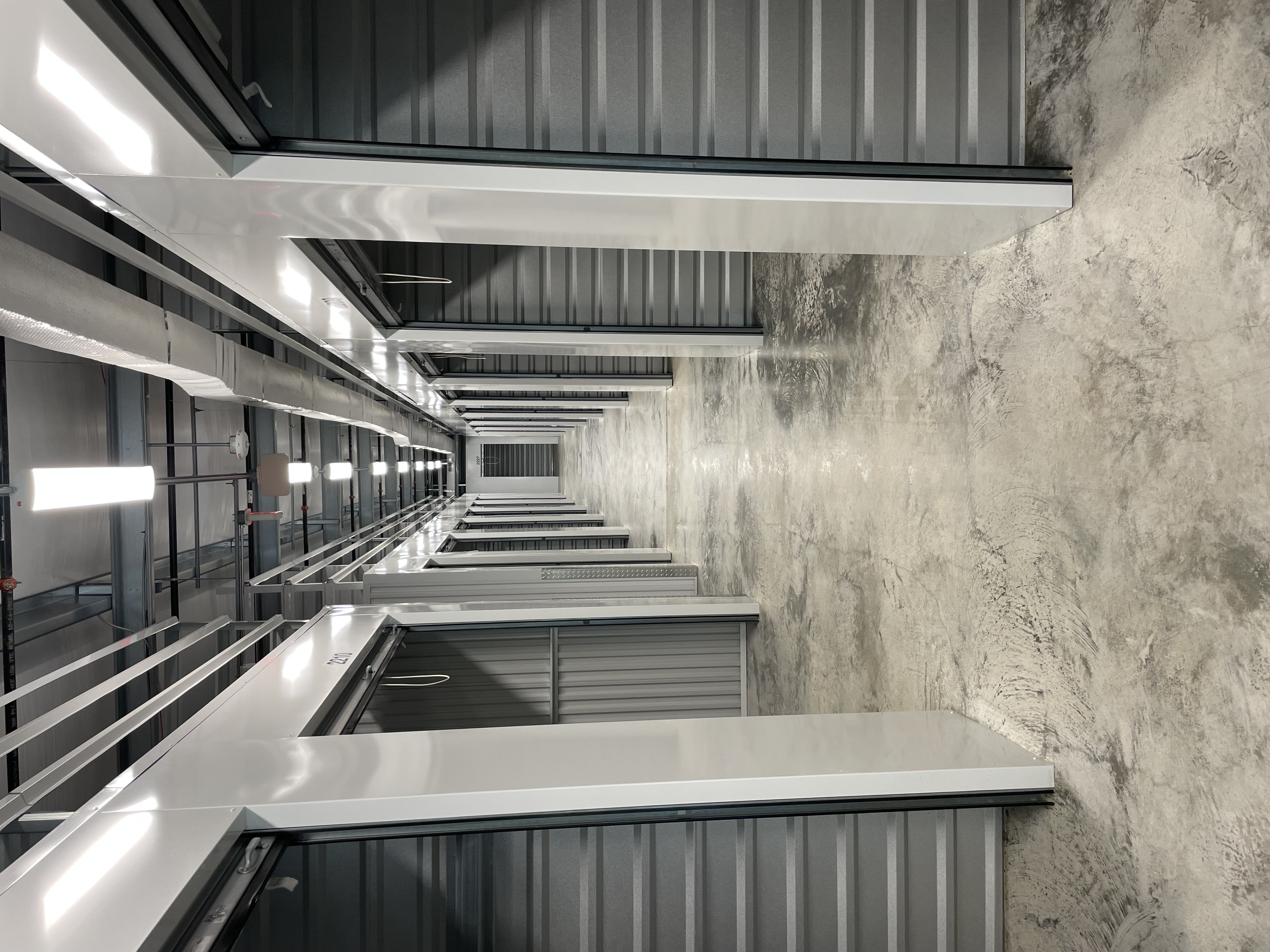A bright Stone Spring Storage hallway with rolling doors lifted open