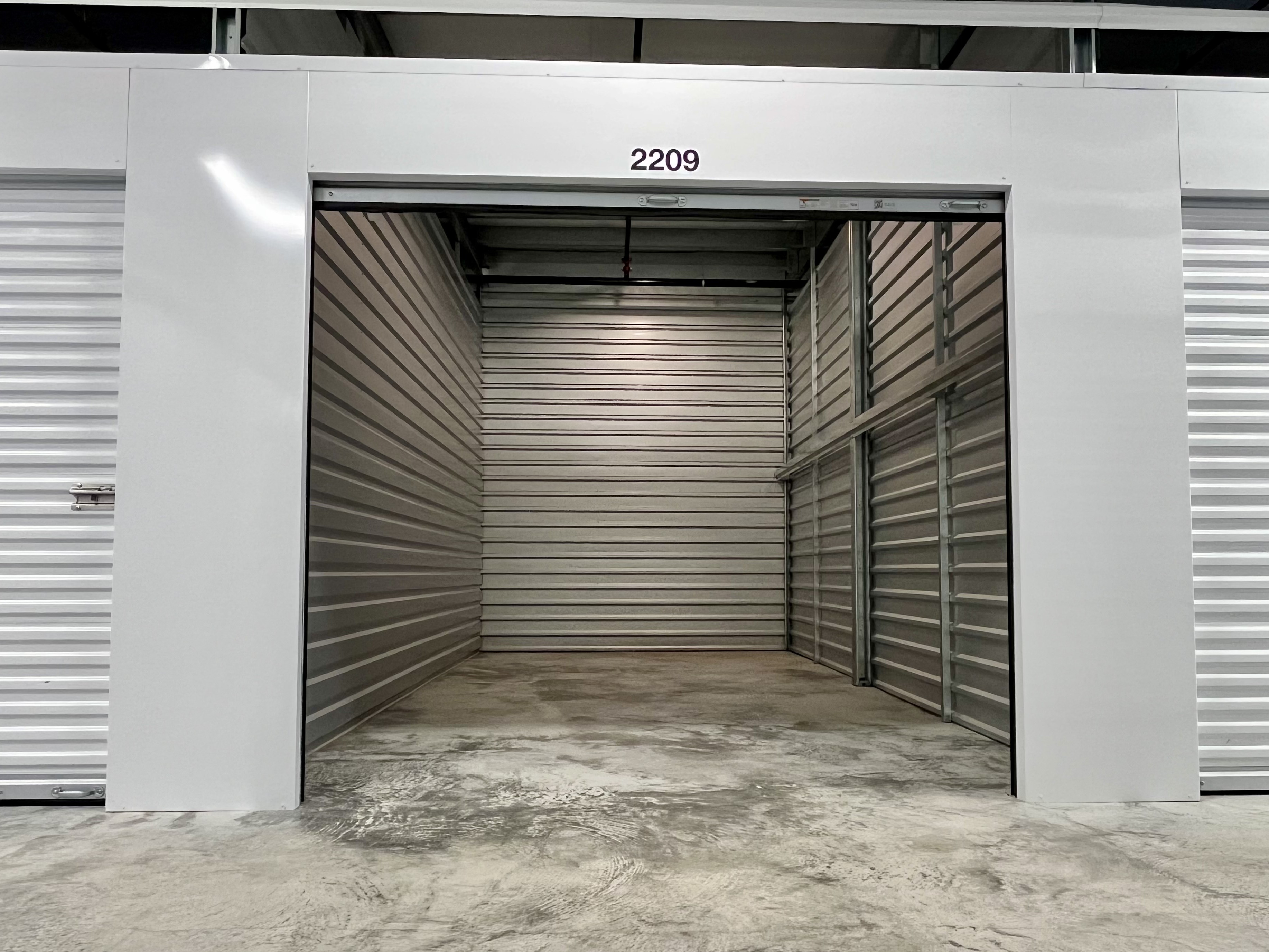 An empty climate-controlled interior storage unit, brightly lit